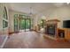 Spacious living room with a fireplace, unique brick flooring, and sliding glass doors to the outside at 3622 Moonlight Dr, Chapel Hill, NC 27516
