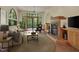 Comfortable living room featuring a fireplace, large windows, and modern furnishings at 3622 Moonlight Dr, Chapel Hill, NC 27516