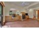 Open living room with a corner fireplace, brick floors, and seamless access to other rooms at 3622 Moonlight Dr, Chapel Hill, NC 27516