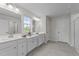 Bright bathroom featuring double sinks, white cabinetry, and ample counter space with decorative lights at 3700 Horton Hill Dr, New Hill, NC 27562
