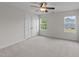 Bright bedroom with a ceiling fan, carpeted floor, and double-door closet at 3700 Horton Hill Dr, New Hill, NC 27562