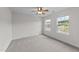Neutral bedroom with carpet flooring, and two windows to bring natural light into the living space at 3700 Horton Hill Dr, New Hill, NC 27562