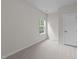 Neutral bedroom with a window, carpet, and a white door at 3700 Horton Hill Dr, New Hill, NC 27562
