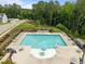 Aerial shot of a community pool with plenty of lounge chairs, tables and a lifeguard stand at 3700 Horton Hill Dr, New Hill, NC 27562