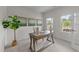 Bright home office featuring a wooden desk, modern art, and natural light at 3700 Horton Hill Dr, New Hill, NC 27562
