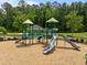 Outdoor playground with slides, a climbing structure, and a wood chip ground covering at 3700 Horton Hill Dr, New Hill, NC 27562