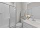 A full bathroom with a tiled shower and a sink and vanity with a white flower at 3700 Horton Hill Dr, New Hill, NC 27562
