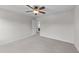A bright, carpeted bedroom featuring a ceiling fan and an open doorway at 3700 Horton Hill Dr, New Hill, NC 27562