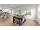 A dining room with hardwood floors, windows, and a glass door out to a deck or patio at 3700 Horton Hill Dr, New Hill, NC 27562