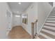 Bright foyer with hardwood floors, staircase, and modern artwork at 3700 Horton Hill Dr, New Hill, NC 27562