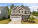Charming two-story home featuring a well-manicured front yard and a two-car garage at 3700 Horton Hill Dr, New Hill, NC 27562