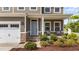 Inviting front porch of a brown home featuring stone accents and lovely landscaping at 3700 Horton Hill Dr, New Hill, NC 27562