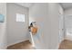 Hallway with hardwood floors and a window and bags on hooks on the wall at 3700 Horton Hill Dr, New Hill, NC 27562