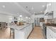 Bright kitchen island with granite countertops, stainless steel appliances, and open living area at 3700 Horton Hill Dr, New Hill, NC 27562