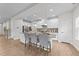 Modern kitchen featuring a large island with seating, stainless steel appliances, and white cabinetry at 3700 Horton Hill Dr, New Hill, NC 27562