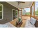 Screened porch with a ceiling fan, furniture, a view of the backyard, and a sliding glass door at 3700 Horton Hill Dr, New Hill, NC 27562