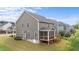 This exterior view highlights a spacious yard with a screened porch and wooden deck at 3700 Horton Hill Dr, New Hill, NC 27562