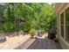 Landscaped backyard featuring a wooden deck, fire pit, and lush greenery for outdoor entertainment at 401 Robert Hunt Dr, Carrboro, NC 27510