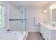 Modern bathroom showcasing a glass-enclosed shower, tub, and double sink vanity at 401 Robert Hunt Dr, Carrboro, NC 27510