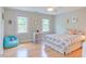 Bright bedroom with hardwood floors, a colorful bedspread, and natural light at 401 Robert Hunt Dr, Carrboro, NC 27510