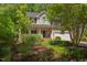 Charming two-story home with manicured landscaping, inviting front porch, and attached two car garage at 401 Robert Hunt Dr, Carrboro, NC 27510