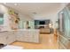 Open kitchen features a kitchen island with seating, stainless appliances, floating shelves and connects to the living area at 401 Robert Hunt Dr, Carrboro, NC 27510