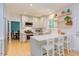 Modern kitchen with white cabinets, an island with bar stool seating, and stainless steel appliances at 401 Robert Hunt Dr, Carrboro, NC 27510
