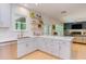 Open-concept kitchen with island, stainless steel appliances, and views to the cozy living room at 401 Robert Hunt Dr, Carrboro, NC 27510
