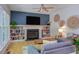 Cozy living room featuring a fireplace with built-in bookshelves, a ceiling fan and decorative wall hangings at 401 Robert Hunt Dr, Carrboro, NC 27510