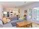 Spacious living room with view to kitchen and backyard featuring a comfortable sectional couch and wood floors at 401 Robert Hunt Dr, Carrboro, NC 27510