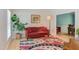 Comfortable living room features a red sofa, bright decor, and opens into the dining room at 401 Robert Hunt Dr, Carrboro, NC 27510