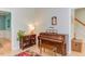 Living room with a piano, book shelf, and staircase at 401 Robert Hunt Dr, Carrboro, NC 27510