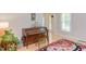 Bright living room featuring a piano, hardwood floors, and a colorful area rug at 401 Robert Hunt Dr, Carrboro, NC 27510