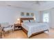 Comfortable bedroom featuring natural light, neutral walls, hardwood floors, and a plush bed at 401 Robert Hunt Dr, Carrboro, NC 27510