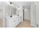 Well-lit bathroom with double sink vanity, large mirror, and modern fixtures at 412 W Stallings St, Clayton, NC 27520