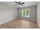 Bright bedroom features wood-look floors, neutral walls, a ceiling fan, and a window with natural light at 412 W Stallings St, Clayton, NC 27520