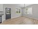 Bright dining area with modern light fixture, neutral walls, and door to the backyard at 412 W Stallings St, Clayton, NC 27520