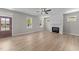Living room with light floors, fireplace, large windows, and a view to the front door at 412 W Stallings St, Clayton, NC 27520
