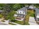 An aerial view of a two-story white home featuring a metal roof, front porch, and landscaped front yard at 412 W Stallings St, Clayton, NC 27520