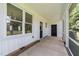 Covered back porch offering an airy outdoor living space with views of the yard at 412 W Stalllings St, Clayton, NC 27520