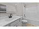 Bathroom with a modern vanity, sleek fixtures, and a shower-tub combo at 412 W Stalllings St, Clayton, NC 27520