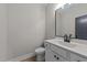 Powder room with a vanity and mirror featuring black hardware and fixtures at 412 W Stalllings St, Clayton, NC 27520
