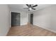 Bedroom with ceiling fan, closet, and wood-look laminate flooring at 412 W Stalllings St, Clayton, NC 27520