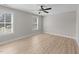 Bright, airy bedroom featuring hardwood floors, two windows and a ceiling fan at 412 W Stalllings St, Clayton, NC 27520