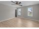 Spacious bedroom featuring hardwood floors, windows providing ample sunlight, and a neutral color at 412 W Stalllings St, Clayton, NC 27520