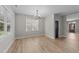 Dining room features luxury vinyl plank flooring, modern light fixture and backyard access at 412 W Stalllings St, Clayton, NC 27520