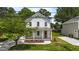 Charming two-story white home featuring a covered porch with elegant columns and landscaped front yard at 412 W Stallings St, Clayton, NC 27520