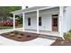 Home featuring a covered front porch, columns, landscaping, and a wood door at 412 W Stalllings St, Clayton, NC 27520