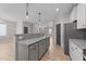 Open concept kitchen showcasing granite counters, island with bar seating and adjacent living area at 412 W Stalllings St, Clayton, NC 27520