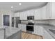 Bright kitchen features white cabinets, granite countertops, and stainless steel appliances at 412 W Stalllings St, Clayton, NC 27520